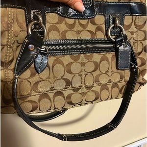 Coach hand bag. Signature brown with a black